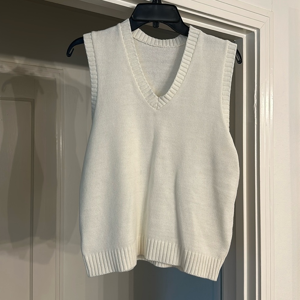 White sleeveless v neck sweater. No tags. Would fit m/l